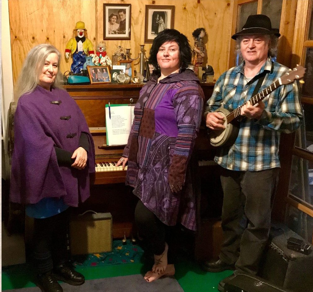 Jensen family band Jensen family stands in front of a piano